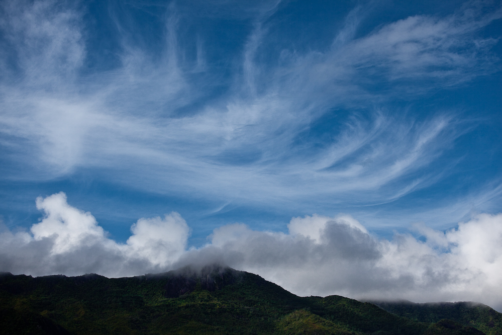 Cirrus Fibratus, Cirrus Uncinus and Cirrus Spissatus with Cumulus clouds on the mountains